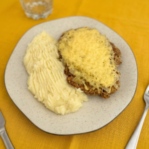 Milanesa de pollo con queso y cebolla